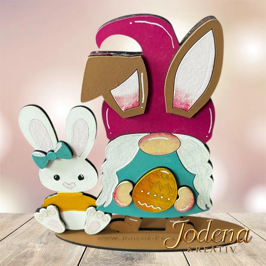 Osterwichtelin_Osterhase_Osterei_aufHolztisch_rosaHintergrund_vonoben
